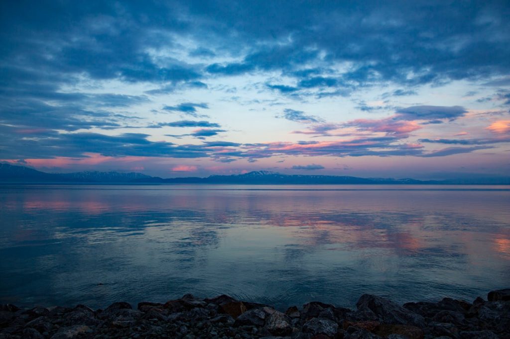 pexels photo 10792643 Calm twilight scene over a tranquil lake with majestic clouds and colorful reflections.